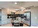 Modern kitchen featuring stainless steel appliances, sleek cabinetry, and a cozy dining area at 120 S Pennsylvania St # 207, Denver, CO 80209