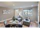 Cozy living room featuring a comfortable seating area, hardwood floors, and ample natural light at 120 S Pennsylvania St # 207, Denver, CO 80209