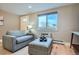 Bright and airy living room with large windows and a comfortable seating arrangement at 120 S Pennsylvania St # 207, Denver, CO 80209