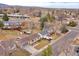 A neighborhood aerial view showcases the property with a spacious yard and mature trees at 6523 S Field Way, Littleton, CO 80123