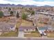 Charming home aerial with a large backyard, mature trees, and mountain backdrop at 6523 S Field Way, Littleton, CO 80123