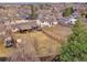 A high angle view shows the home's layout, large fenced yard with patio and hot tub at 6523 S Field Way, Littleton, CO 80123