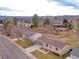 This aerial view captures a well-situated home, showcasing the mature trees and mountain backdrop at 6523 S Field Way, Littleton, CO 80123