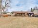 Expansive backyard features a covered deck, lush lawn, and a charming gazebo-covered hot tub at 6523 S Field Way, Littleton, CO 80123