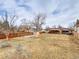 Large fenced backyard featuring mature trees, shed, patio, and garden at 6523 S Field Way, Littleton, CO 80123