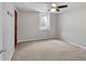 Basement with plush carpet, ceiling fan, window, and door leading to storage at 6523 S Field Way, Littleton, CO 80123