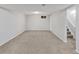 Bright unfinished basement with carpet, stairs, and potential for a customized living space at 6523 S Field Way, Littleton, CO 80123