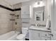 Updated bathroom with a shower and bathtub, modern vanity and decorative tile at 6523 S Field Way, Littleton, CO 80123