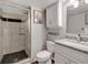 Stylish bathroom with tiled shower, granite countertop, and white cabinets at 6523 S Field Way, Littleton, CO 80123