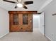 Bedroom with wood accent wall, carpeted floor and ceiling fan at 6523 S Field Way, Littleton, CO 80123