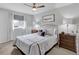 Bedroom features neutral paint, ceiling fan, natural light, carpet, and two side tables at 6523 S Field Way, Littleton, CO 80123