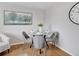 Clean and stylish dining table with modern decor and hardwood floors and neutral color scheme at 6523 S Field Way, Littleton, CO 80123