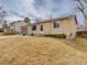 Low angle of small brick and vinyl sided home with xeriscaping and front yard at 6523 S Field Way, Littleton, CO 80123