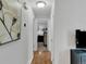 Hallway with hardwood floors leading to bedrooms, with neutral paint and bright lighting at 6523 S Field Way, Littleton, CO 80123