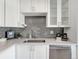 Bright kitchen featuring stainless steel appliances, light countertops, and gray subway tile backsplash at 6523 S Field Way, Littleton, CO 80123