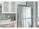 The stainless steel refrigerator and under-cabinet lighting enhances the kitchen's features at 6523 S Field Way, Littleton, CO 80123