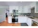 Bright, updated kitchen with stainless appliances, white cabinets and countertops, gray subway backsplash at 6523 S Field Way, Littleton, CO 80123