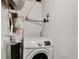 Laundry room with white washing machine and water heater at 6523 S Field Way, Littleton, CO 80123