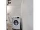 Laundry room with white washing machine and concrete floor at 6523 S Field Way, Littleton, CO 80123