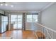Bright living area featuring hardwood floors, natural light, and access to an outdoor deck at 6523 S Field Way, Littleton, CO 80123