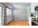 Living area with hardwood floors, stairs, and sliding glass door to outdoor deck at 6523 S Field Way, Littleton, CO 80123