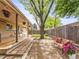 Landscaped backyard with mature trees, seating area and patio at 5995 Estes St, Arvada, CO 80004