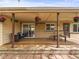 Covered deck with outdoor seating in a large backyard, perfect for entertaining at 5995 Estes St, Arvada, CO 80004