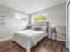 Bedroom featuring a grey headboard and filled with natural light from windows at 5995 Estes St, Arvada, CO 80004