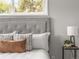 Close-up view of a bed with soft pillows and a lamp sitting on a side table at 5995 Estes St, Arvada, CO 80004
