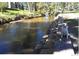 Creek with stone lined bank. A happy dog sits, awaiting a tennis ball at 5995 Estes St, Arvada, CO 80004