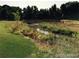 Scenic creek flowing under a charming wooden bridge surrounded by lush greenery at 5995 Estes St, Arvada, CO 80004