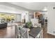 Open-concept dining area with hardwood floors, and convenient flow to the kitchen at 5995 Estes St, Arvada, CO 80004