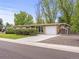 Charming single story home with attached garage, landscaped yard and a concrete driveway at 5995 Estes St, Arvada, CO 80004