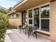 Charming home featuring a cozy front porch with seating, large window, and manicured landscaping at 5995 Estes St, Arvada, CO 80004