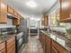 Well-lit kitchen features stainless steel appliances, tile backsplash, and granite countertops at 5995 Estes St, Arvada, CO 80004