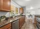 Kitchen features granite countertops, stainless steel appliances, and a view to the dining room at 5995 Estes St, Arvada, CO 80004