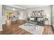 Inviting living room flowing into dining area with hardwood floors and ample natural light at 5995 Estes St, Arvada, CO 80004