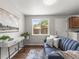 Comfortable living room with hardwood floors, a plush blue sofa and lots of natural light at 5995 Estes St, Arvada, CO 80004