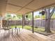 Enjoy the backyard on this covered deck with seating and mature shade trees at 5995 Estes St, Arvada, CO 80004