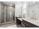 Modern bathroom with a glass enclosed shower, double vanity, and stylish fixtures at 17163 Desert Wine Trl, Parker, CO 80134