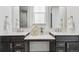 A modern bathroom offers dual sinks, undermount lighting and a large mirror at 17163 Desert Wine Trl, Parker, CO 80134