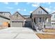 Charming home featuring a stone accented three car garage, covered porch and manicured lawn at 17163 Desert Wine Trl, Parker, CO 80134