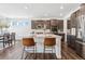 Open kitchen with stainless steel appliances, central island, modern finishes, and bar stool seating at 17163 Desert Wine Trl, Parker, CO 80134