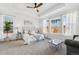 Serene bedroom with tray ceiling, large windows, and comfortable seating area at 17163 Desert Wine Trl, Parker, CO 80134