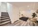 Finished basement featuring a cozy living area with a comfortable white couch at 6102 S Owens Ct, Littleton, CO 80127