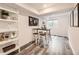 Finished basement boasting a sleek table with stools and decorative shelving at 6102 S Owens Ct, Littleton, CO 80127