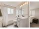 A clean, bright bathroom with gray vanity, tub/shower with white tile, and modern fixtures at 6102 S Owens Ct, Littleton, CO 80127