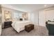 Cozy bedroom featuring plush gray carpet, white bedding, and stylish modern decor and recessed lighting at 6102 S Owens Ct, Littleton, CO 80127