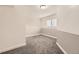 An empty bedroom with soft gray carpet, neutral walls, and bright window awaits personalization at 6102 S Owens Ct, Littleton, CO 80127