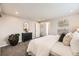A bright bedroom showcases neutral walls, plush carpet, and a black dresser with modern mirror at 6102 S Owens Ct, Littleton, CO 80127